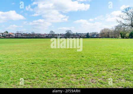 LONDON, UK - MARCH 22, 2021: People enjoy walking in Barnet Playing Fields, part of Dollis Valley Greenwalk route in London between Moat Mount Nature Stock Photo