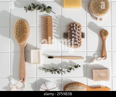 Various eco frendly items from bathroom for face and body care and hygiene on white tiled background. Zero waste concept. Top view Stock Photo