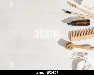 Various eco frendly items - toothbrushes, hairbrush, reusable cotton pads white towel and facial brush on white background. Top view. Copy space Stock Photo