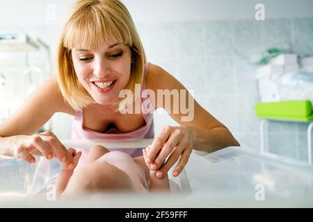 Happy cheerful family. Mother and baby kissing, laughing and hugging Stock Photo