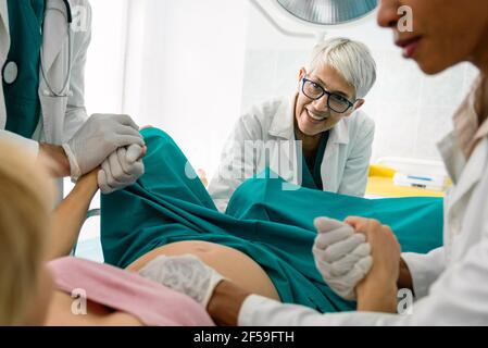 Woman giving birth in labor room of hospital Stock Photo - Alamy