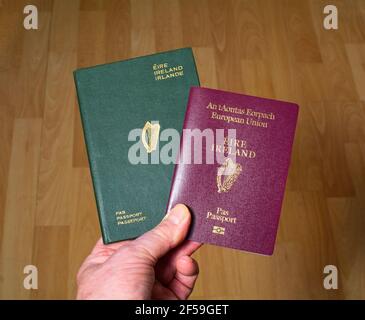 Up to date red color Irish passport (European Union) alongside an old ...