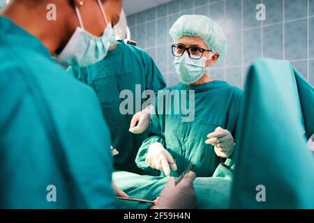 Exhausted surgeons at the emergency room as a sign of stress and overwork Stock Photo