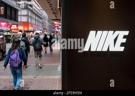 Pedestrians walk past the American multinational clothing brand Under ...