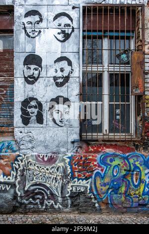 .Old squat building detail, weathered wall, graffiti, urban art, rusty burgalr bars. Linien strasse 206, Mitte, Berlin Stock Photo