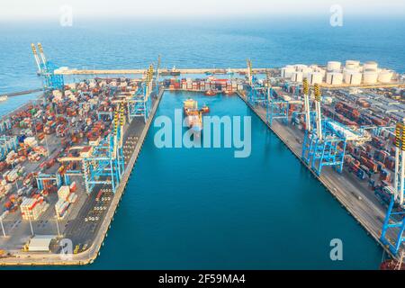 Aerial view from the height of a cargo harbor in a cargo seaport, a sailing ship with containers goods. Malta, Il Brolli Marsaxlokk, Malta-Freeport. 0 Stock Photo