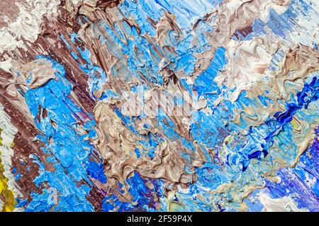 Brown and blue brush strokes, stains and dripping blobs of colored acrylic paint on the artist's palette. Abstract modern background Stock Photo