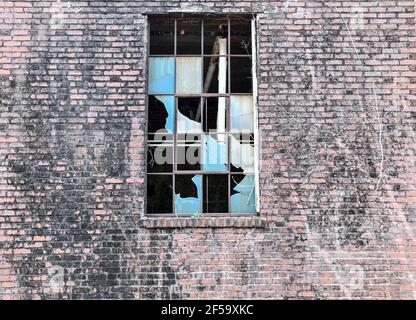 weathered old broken window in abandoned building Stock Photo