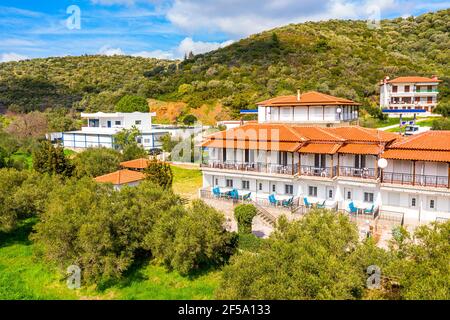 Aerial drone top view from above to countryside summer landscape with white semi-detached cottage house among green olive trees garden on mountains, b Stock Photo