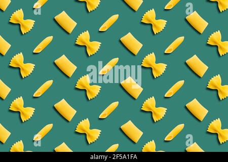 Italian pasta pattern on a green background. Top view. Stock Photo