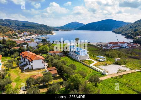 Drone top view of Europe rural landscape with countryside village by forest lake valley. Aerial panorama of white residential houses among Greece gree Stock Photo