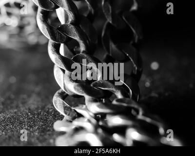 Cuban link silver chain on black background. Stock Photo