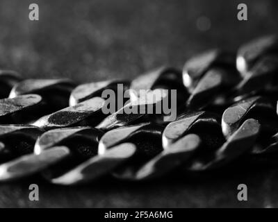 Cuban link silver chain on black background. Stock Photo