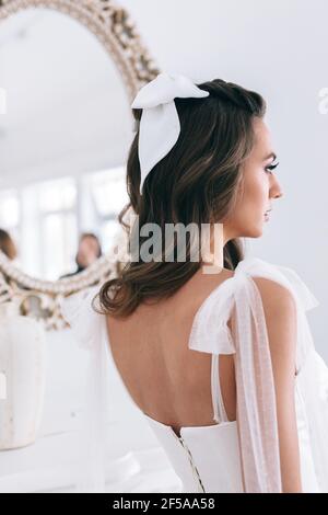 Close-up of beautiful stylish bride with an elegant hairstyle view from the back . Studio shot Stock Photo