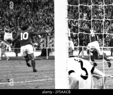 England versus West Germany 1966 World Cup Final, Wembley Stadium England's Martin Peters turns to celebrate his 18th minute goal with Geoff Hurst and Roger Hunt as West Germany's Hans Tilkowski picks the ball out of the net and Number 3, Karl-Heiz Schnellinger is left on the deck  Photo by Tony Henshaw Archive Stock Photo