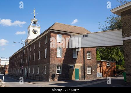 View of the Clocktower Building of the Old Naval Store House at Chatham Historic Dockyard, Kent England UK on a sunny day with blue sky skies. (121) Stock Photo