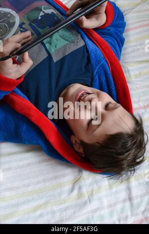 happy boy playing on tablet Stock Photo