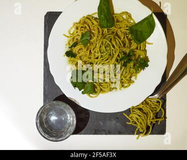 Top view of Delicious Spaghetti with pesto sauce and basil and p Stock Photo
