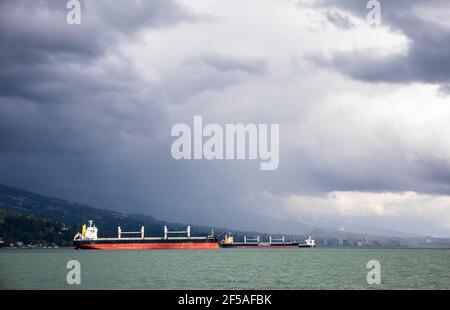 Container ships wait in harbor outside of Vancouver port Stock Photo