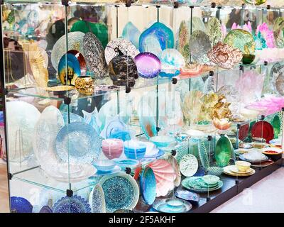 Decorative colored glass dishes in the store Stock Photo