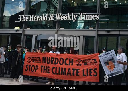 Melbourne, Australia. 25th March 2021. Climate activist group Extinction Rebellion gather outside the Herald & Weekly Times building, protesting against Rupert Murdoch’s suppression of the issue of climate change in Australia’s news. This follows a week of disruptive action by the group in order to raise public and federal awareness of climate change. Credit: Jay Kogler/Alamy Live News Stock Photo