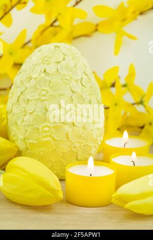 Yellow Easter egg and tulips on wooden background Stock Photo