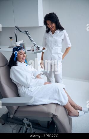 Young woman in a silicone cap smiling during the EEG Stock Photo