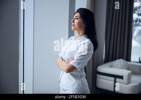 Pensive middle-aged physician waiting for a patient Stock Photo