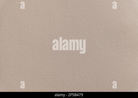 House wall with texture painted in beige. Stock Photo