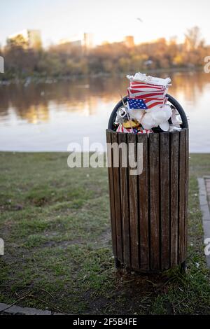 Overflowing waste from the full container placed in a public park. Stock Photo