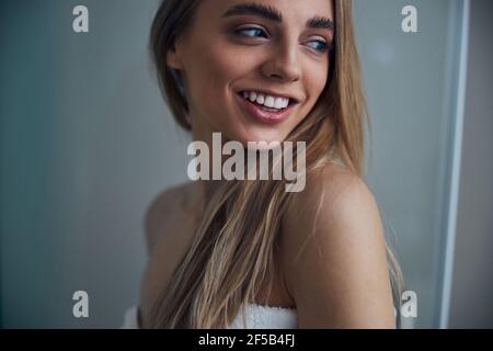 Pleased lady wrapped in a terry bath towel Stock Photo