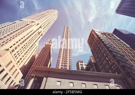 Looking up at Manhattan skyscrapers, color toned picture, New York City, USA. Stock Photo