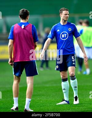 Northern Ireland's Jonny Evans (right) warms up on the pitch ahead of the FIFA 2022 World Cup qualifying group C match at Stadio Ennio Tardini, Parma. Picture date: Thursday March 25, 2021. Stock Photo