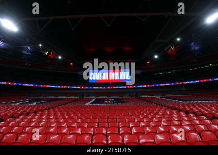 Come on England displayed on the big screen in empty stands during the FIFA 2022 World Cup qualifying match at Wembley Stadium, London. Picture date: Thursday March 25, 2021. Stock Photo