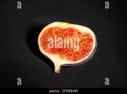 sliced figs on black background Stock Photo