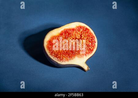 sliced figs on blue background Stock Photo