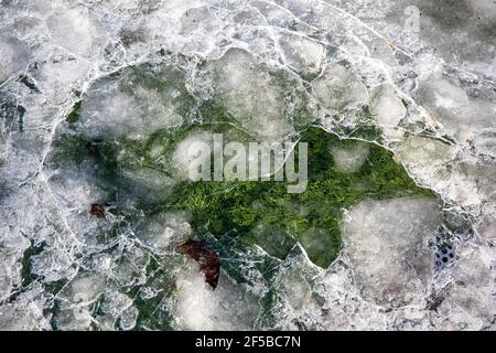 Football or soccer fiel artificial turf under broken ice Stock Photo