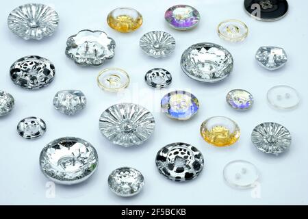Sew-on plastic buttons transparent. Decorative buttons for clothes on a white background. Sewing accessories for clothes and bags. Stock Photo