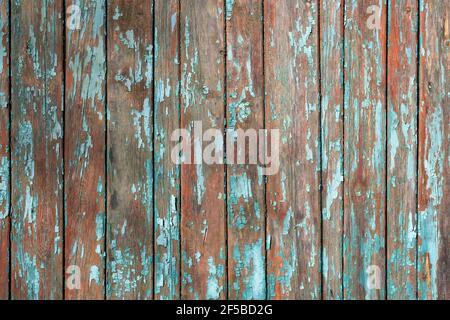 Green old cracked paint on a wooden surface. Background from wooden boards with peeling paint top view. Wooden planks covered with old faded oil paint Stock Photo
