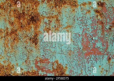 Metal sheet rusty faded texture. Peeling turquoise paint on a concrete wall. Steel plate background. Stock Photo