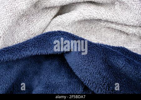 Soft plush fabric close up. Blue and gray pile, unnatural fabrics for decorative pillows. Low-pile synthetic material. Stock Photo