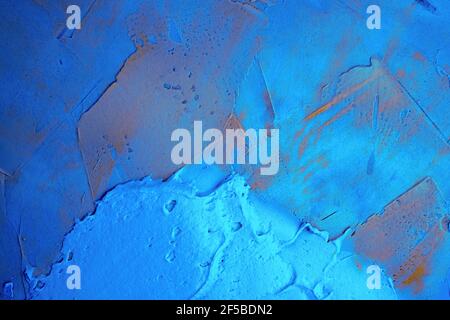 The metal surface of the door is coated with pearlescent paint. Plaster on the surface in blue. Grunge texture, background. Stock Photo