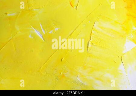 bright yellow abstract surface. Yellow and white background with putty texture. Wall background covered with putty. Stucco Surface. Stock Photo
