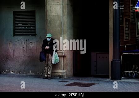 Old man standing in the street. Stock Photo