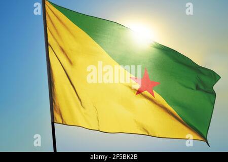 French Guiana flag waving on the wind in front of sun Stock Photo