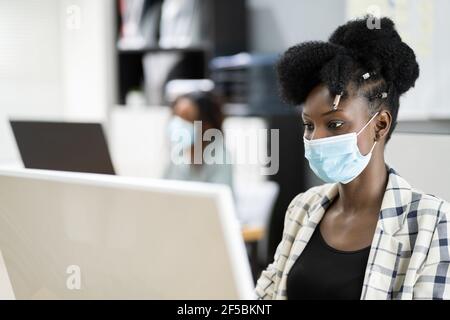 Business People In Medical Covid Face Masks Stock Photo