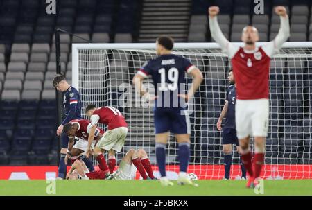 Austria's Sasa Kalajdzic (on ground) after scoring their side's second goal during the FIFA 2022 World Cup qualifying match at Hampden Park, Glasgow. Picture date: Thursday March 25, 2021. Stock Photo