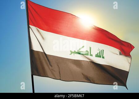 Iraq flag waving on the wind in front of sun Stock Photo