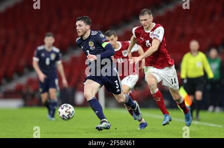 Scotland's Andrew Robertson (left) and Austria's Sasa Kalajdzic in action during the FIFA 2022 World Cup qualifying match at Hampden Park, Glasgow. Picture date: Thursday March 25, 2021. Stock Photo