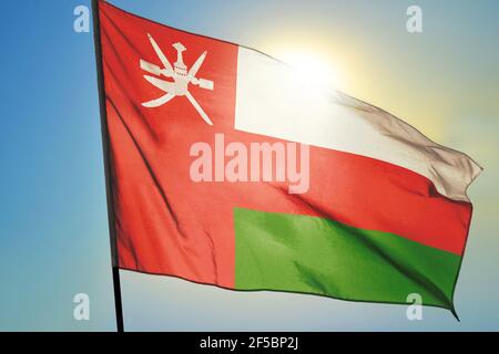Oman flag waving on the wind in front of sun Stock Photo